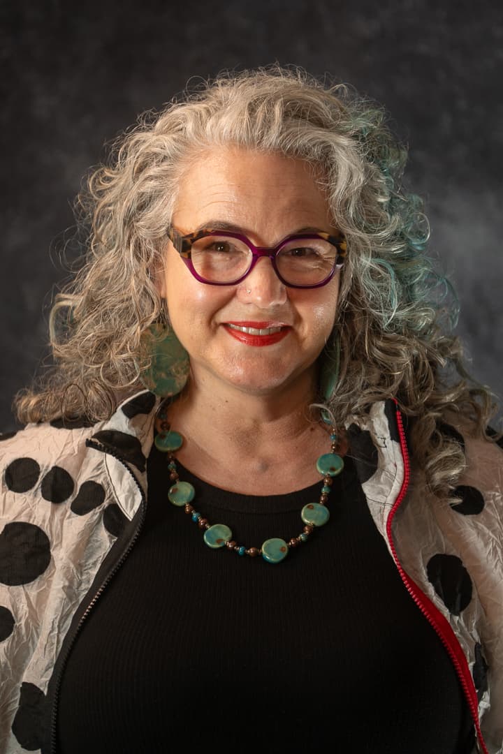 Studio headshot lit against a clean backdrop